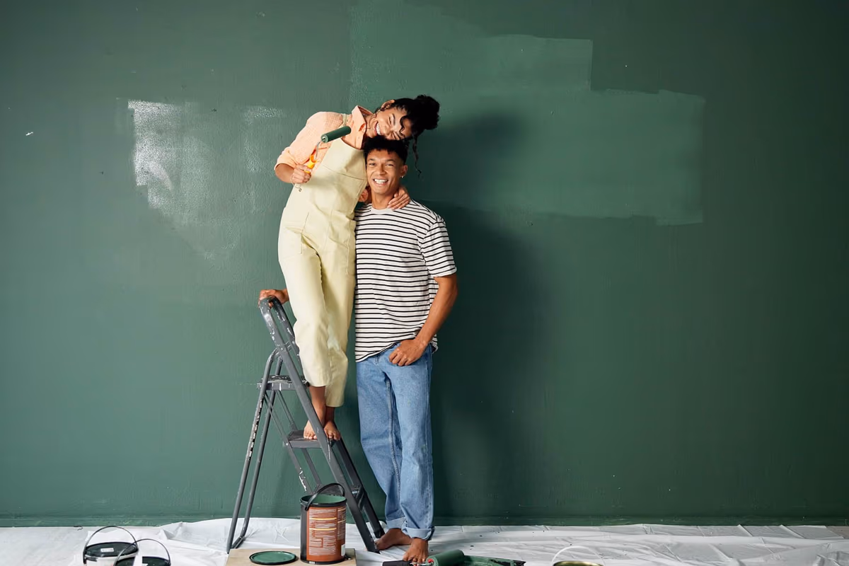 Couple painting their new home